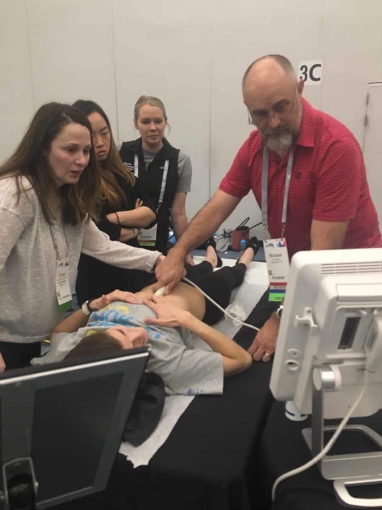 Ultrasound instructor teaching PA student to use an ultrasound at 2019 AAPA conference